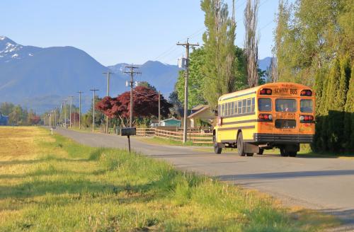 A school bus drives through a country road in an agricultural valley on July 10, 2019.