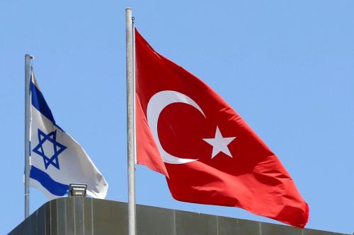 A Turkish flag flutters atop the Turkish embassy as an Israeli flag is seen nearby, in Tel Aviv, Israel June 26, 2016.